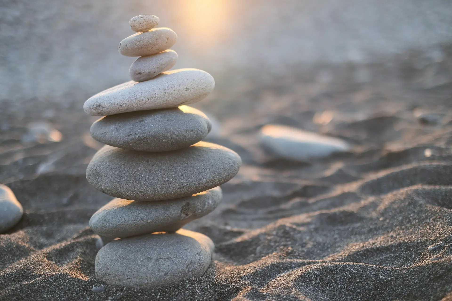 stack of stones on brown sand